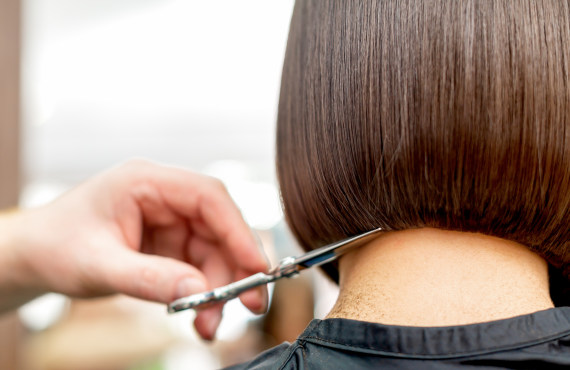 Stylist cutting hair